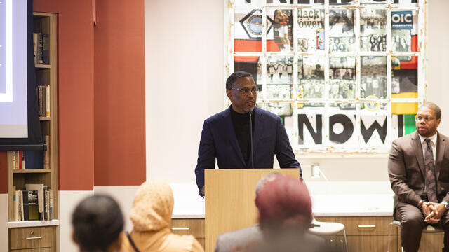 Rev. Gregory Holston speaking at a podium