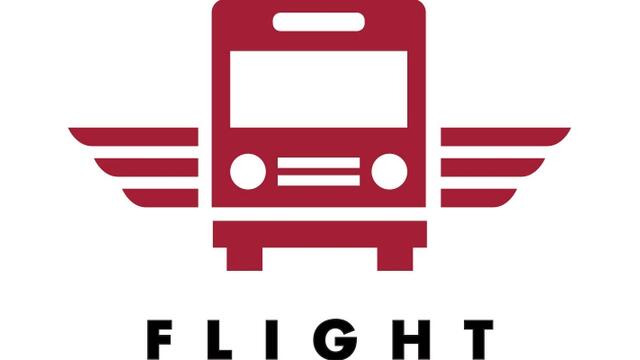 A red bus with wings over the word flight.