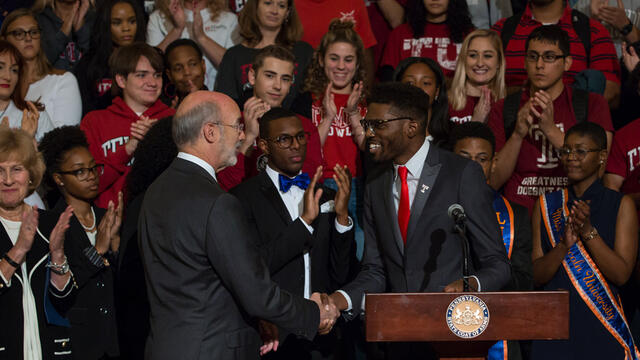 Gov. Tom Wolf shakes hands with student body President Tyrell Mann-Barnes