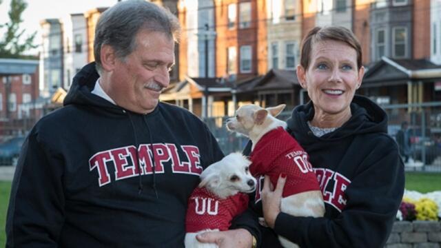 Gene and Cathy Salkind posing in Philadelphia with two small dogs.