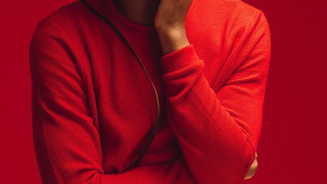 Kalen Allen posing in red.