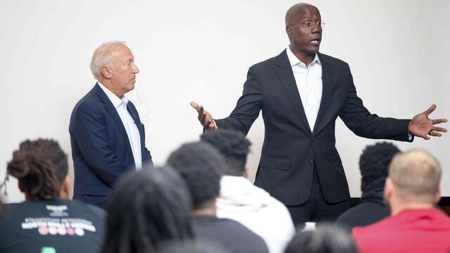 Board of Trustees Chair Mitchell Morgan and President Jason Wingard addressing the football team.