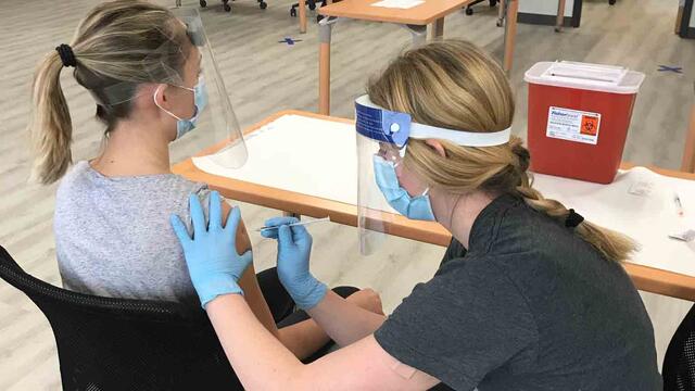 Temple School of Pharmacy students being trained to give vaccines.