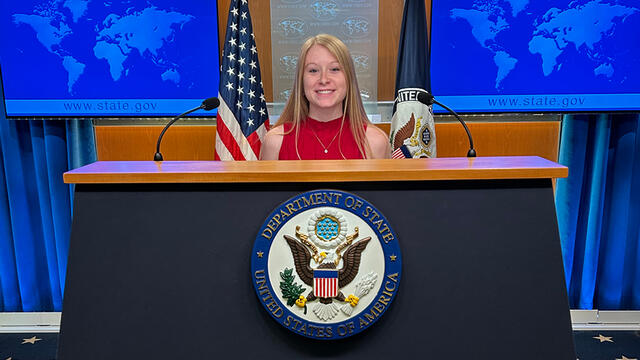 Mergen at State Department podium