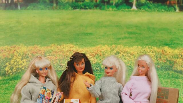 A photo of Barbie dolls having a picnic.