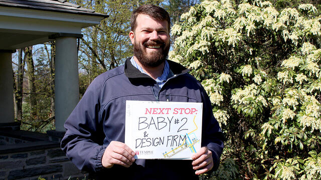 A man in a blue jacket standing on Temple s Ambler Campus.