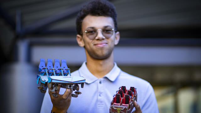 Johns holds two roller coaster model cars