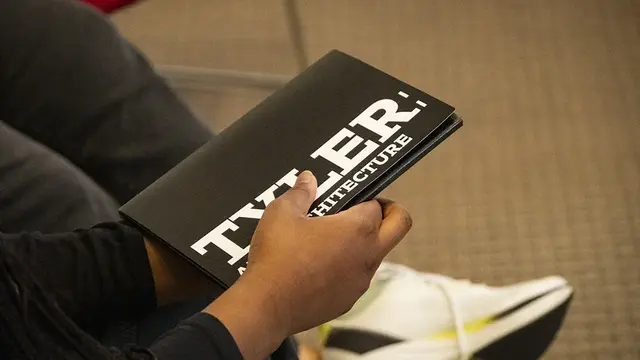 closeup of a student holding Tyler admissions print materials