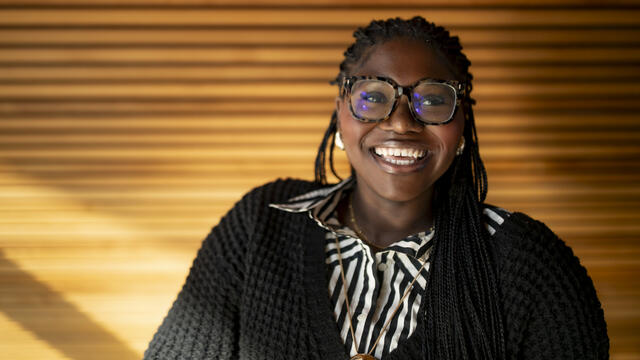 A student smiles in Charles Library