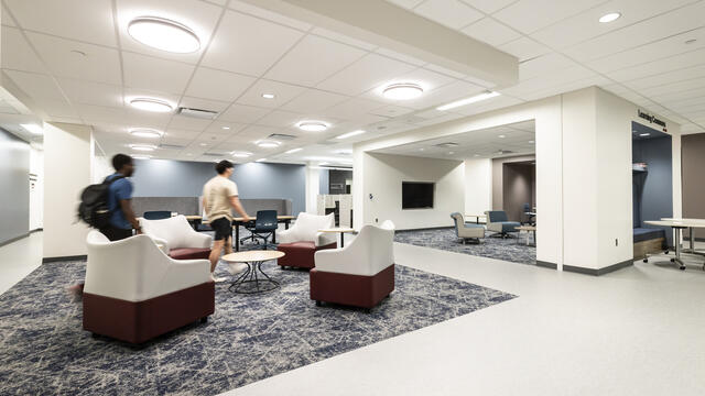 Students walking inside of the Christopher and Julie Barnett Essential Needs Hub