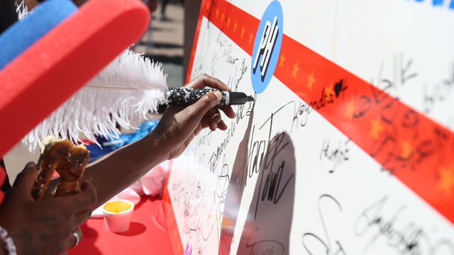 Hands signing the Phambassador pledge