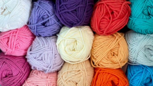 Five rows of yarn in a variety of colors. 