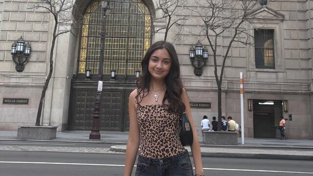 Jasmine Mehta standing in front of Wells Fargo building.