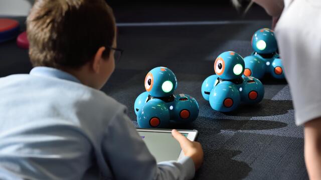 Image of a child playing with robot toys.