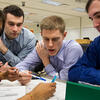 Four students around a table working on an assignment.