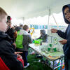 An exhibitor at Temple EarthFest 2015 talking to children about his project.