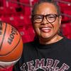Professor Karen Turner poses with a basketball in the Liacouras Center.