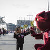 A little girl giving Hooter a high five at a tailgate outside Lincoln Financial Field.