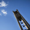 The Bell Tower and a bright blue sky with a few white clouds in the background.