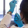 Researcher holding up a syringe