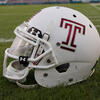A white Temple football helmet with a cherry Temple