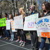 Students holding signs during a walk to raise awareness around sexual assault.