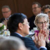 A female faculty member applauding during Temple s Faculty Awards Luncheon.