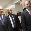 Three men in suits touring the new medical suite at Temple s dental school.