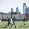 Temple men s soccer team playing at the new sports complex with the Philadelphia skyline in the background.