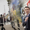 A student standing in front of the C-SPAN Bus along 13th Street.