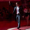 Pepe Sanchez waving as he walks across a gym.