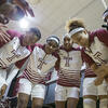 The women s basketball team having a team huddle.