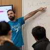 Assistant Professor Daniele Ramella pointing to a whiteboard while teaching.