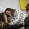 A female Temple student interacting with high school students in a classroom.