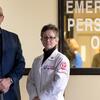 Surgeon Amy Goldberg and outreach coordinator Scott Charles standing by ER doors