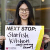Lei Zhao holding a sign for her next stop, Starfish Kitchen.