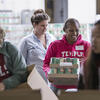 Volunteers working together to package food.
