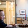 Mark Ovington, 5, sitting in his adaptive chair made of cardboard