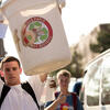 a student holding up his recycling bin