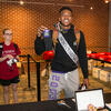 male student wearing a homecoming sash donates socks
