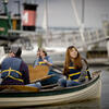 students and professor on a row boat
