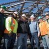 Construction workers standing together at the library site
