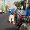 men cleaning the street near Temple's campus