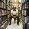 Hazim Hardeman sitting among the stacks at Paley Library.