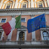 Image of the Italian and European flags on a building.