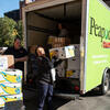 people unloading a Giant truck packed with donations