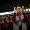 President Richard M. Englert clapping in the stands among Temple students at a basketball game.