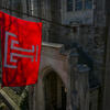 Temple University flag flying in front of Sullivan Hall