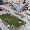 students lounging on the green space atop Anderson Hall