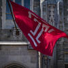 Image of the cherry and white Temple T flag outside of Sullivan Hall on Main Campus.